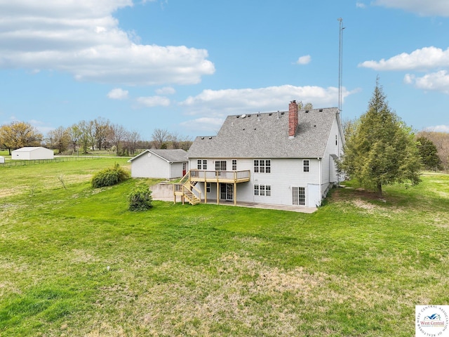 29950 Binder Rd, Green Ridge, MO 65332 - back of house with a wooden deck, a patio, a chimney, and a yard