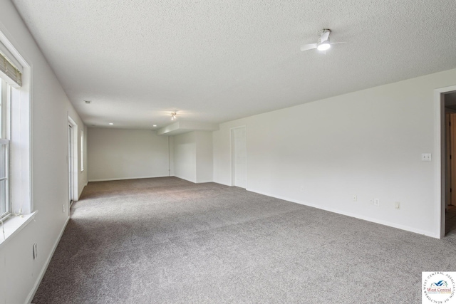 29950 Binder Rd, Green Ridge, MO 65332 - carpeted spare room with a textured ceiling, ceiling fan, and baseboards