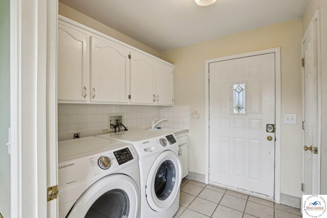 29950 Binder Rd, Green Ridge, MO 65332 - laundry area featuring cabinet space, washer and clothes dryer, and light tile patterned flooring