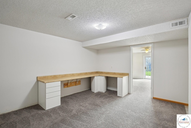 29950 Binder Rd, Green Ridge, MO 65332 - unfurnished office featuring dark colored carpet, a textured ceiling, and built in study area