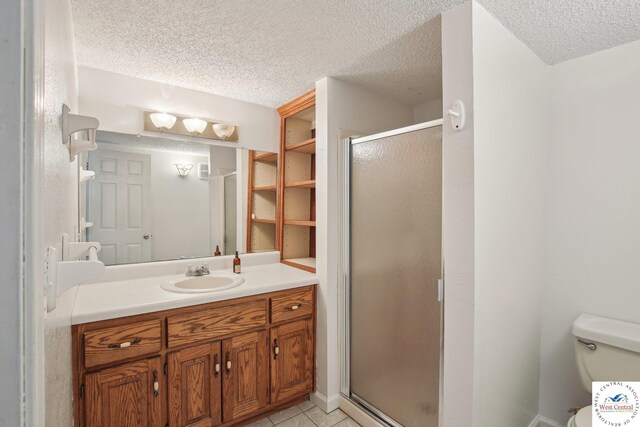 29950 Binder Rd, Green Ridge, MO 65332 - full bathroom featuring a textured ceiling, vanity, a shower stall, tile patterned flooring, and toilet