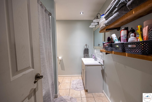 782 SE 250th Rd, Clinton, MO 64735 - clothes washing area featuring baseboards, a sink, and light tile patterned floors