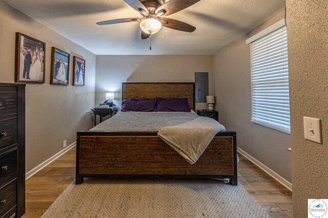 782 SE 250th Rd, Clinton, MO 64735 - bedroom featuring baseboards, a textured wall, and wood finished floors