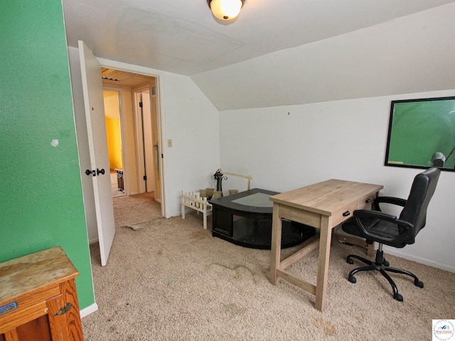 carpeted home office featuring lofted ceiling