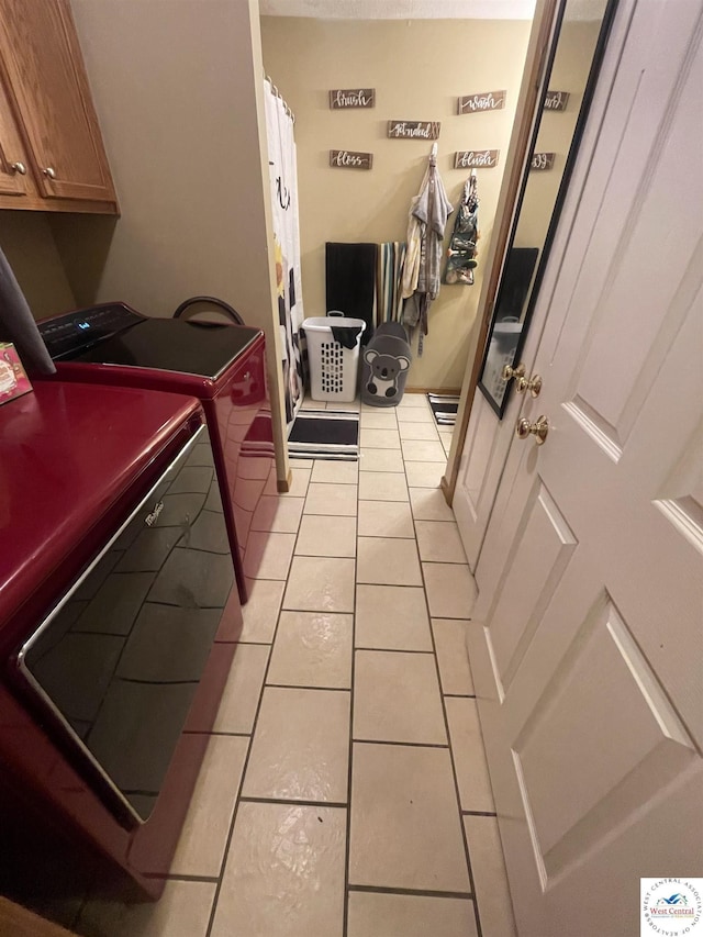 725 N Max Stevens St, Adrian, MO 64720 - washroom featuring cabinet space, separate washer and dryer, and light tile patterned flooring