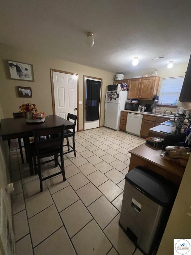 725 N Max Stevens St, Adrian, MO 64720 - kitchen with white appliances and light tile patterned flooring