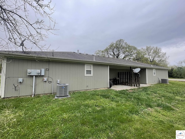 725 N Max Stevens St, Adrian, MO 64720 - rear view of house featuring central AC, a lawn, and a patio area