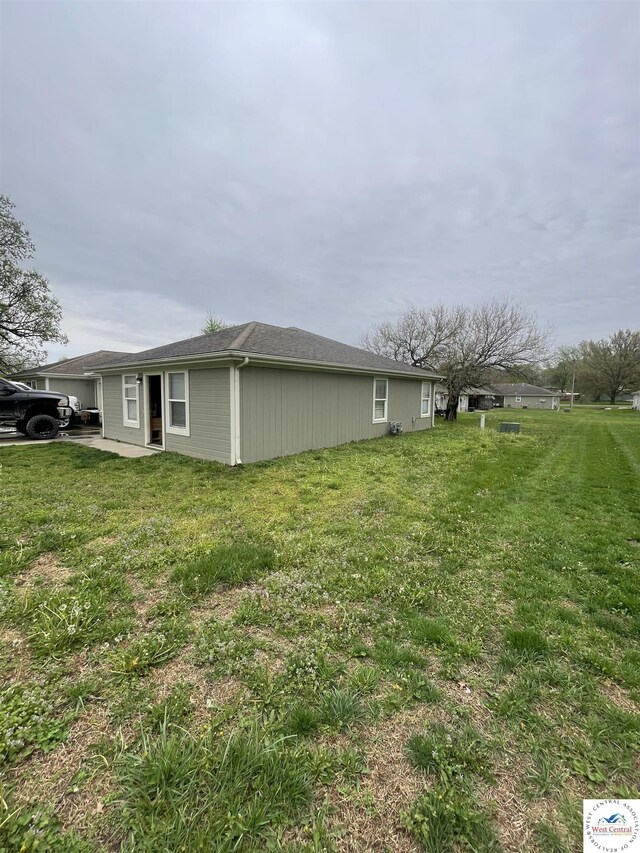 725 N Max Stevens St, Adrian, MO 64720 - view of property exterior featuring a lawn