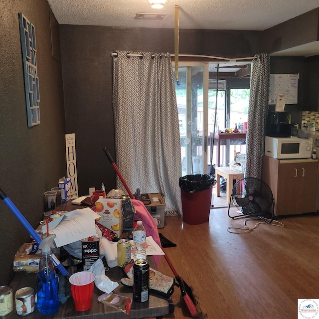 102 S Feaster St, Windsor, MO 65360 - dining room with wood finished floors and a textured ceiling