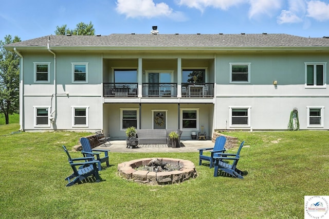 917 N Washboard Rd, Sibley, MO 64088 - rear view of house featuring a fire pit, a balcony, a yard, and stucco siding