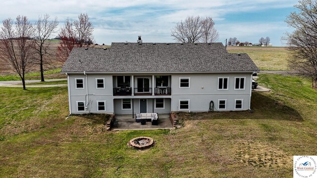 917 N Washboard Rd, Sibley, MO 64088 - rear view of property featuring a patio area, a yard, an outdoor living space with a fire pit, and a shingled roof