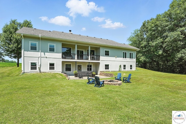 917 N Washboard Rd, Sibley, MO 64088 - back of property with an outdoor fire pit, a yard, stucco siding, and a patio area