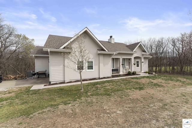 917 N Washboard Rd, Sibley, MO 64088 - view of front of home featuring roof with shingles, a chimney, a front lawn, and a porch