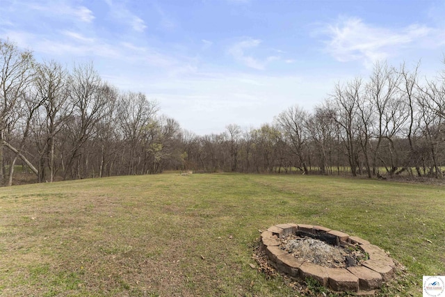 917 N Washboard Rd, Sibley, MO 64088 - view of green lawn with an outdoor fire pit and a view of trees