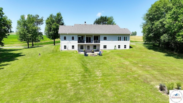 917 N Washboard Rd, Sibley, MO 64088 - back of property with a lawn, stucco siding, a balcony, and a patio area