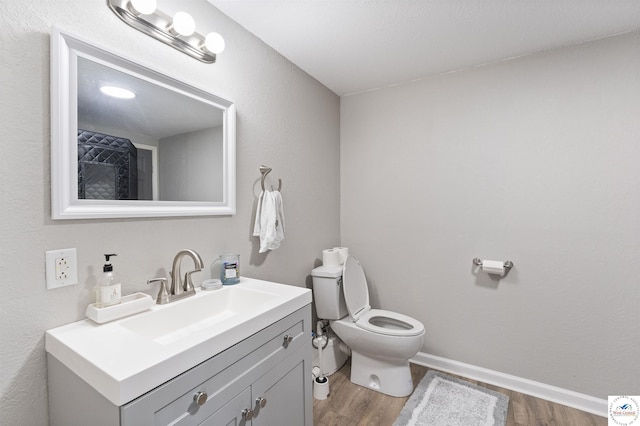 917 N Washboard Rd, Sibley, MO 64088 - bathroom featuring wood finished floors, toilet, vanity, and baseboards