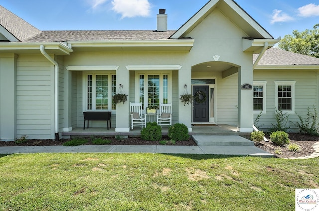 917 N Washboard Rd, Sibley, MO 64088 - entrance to property with a porch, a chimney, roof with shingles, and a yard
