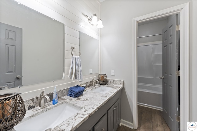 917 N Washboard Rd, Sibley, MO 64088 - bathroom featuring wood finished floors, double vanity, and shower / washtub combination