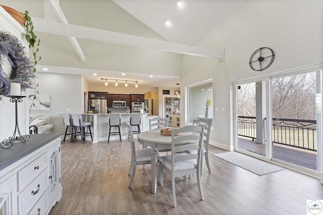 917 N Washboard Rd, Sibley, MO 64088 - dining area with high vaulted ceiling, wood finished floors, baseboards, and recessed lighting