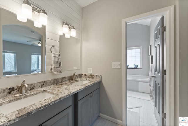 917 N Washboard Rd, Sibley, MO 64088 - bathroom with ceiling fan, double vanity, baseboards, and a tub