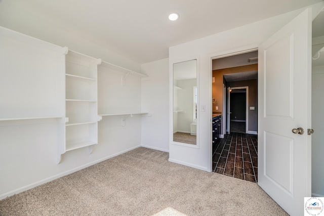 unfurnished bedroom featuring dark colored carpet, baseboards, and recessed lighting