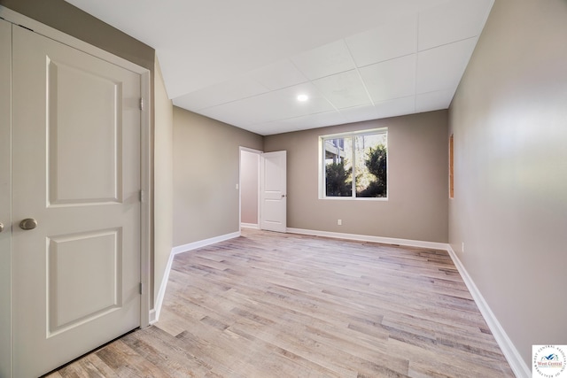 unfurnished bedroom with light wood-type flooring, baseboards, and recessed lighting