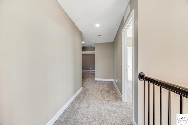 hall featuring light carpet, baseboards, and recessed lighting