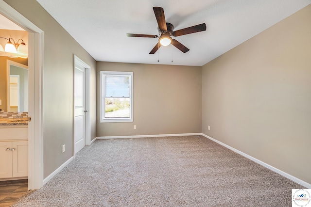 empty room with ceiling fan, baseboards, and carpet flooring