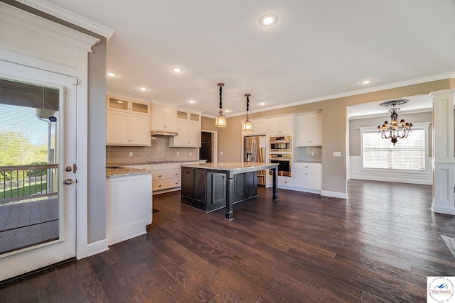 kitchen with a chandelier, white cabinets, stainless steel appliances, tasteful backsplash, and recessed lighting