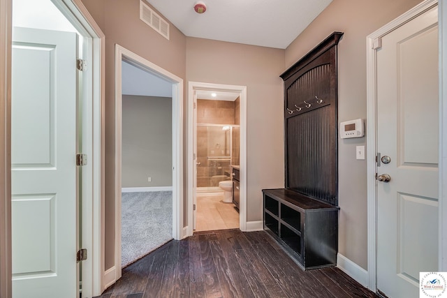 mudroom featuring dark wood-style flooring and baseboards