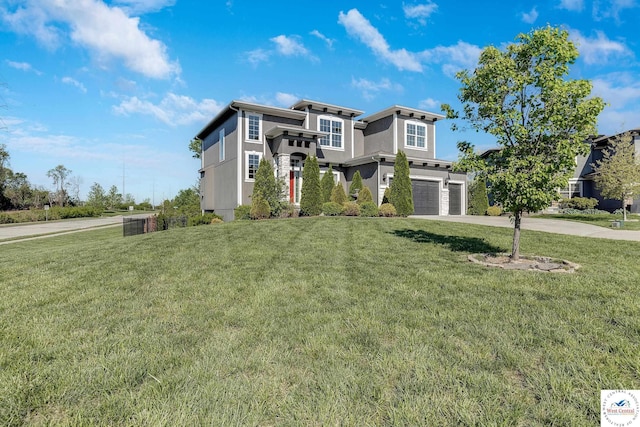 view of front facade with an attached garage, concrete driveway, a front lawn, and stucco siding