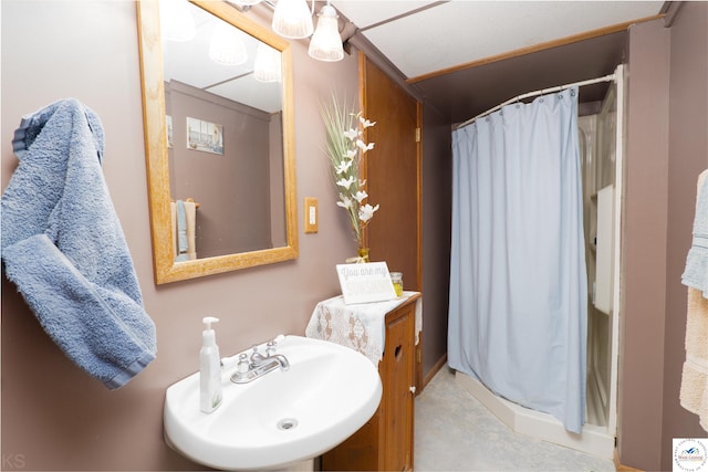 full bathroom featuring a stall shower and a sink