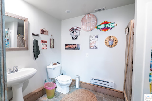 bathroom featuring a baseboard radiator, toilet, a sink, baseboards, and visible vents