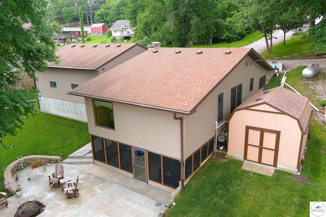 31150 Highview Rd, Edwards, MO 65326 - rear view of property with a patio, a yard, a shingled roof, and a sunroom