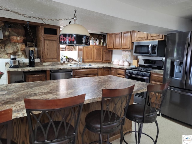 31150 Highview Rd, Edwards, MO 65326 - kitchen with stainless steel appliances, a sink, brown cabinets, a kitchen breakfast bar, and open shelves