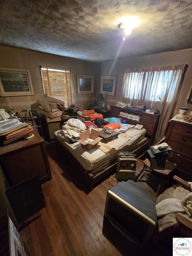 808 E 19th St, Sedalia, MO 65301 - bedroom with dark wood-style flooring, a textured ceiling, and multiple windows