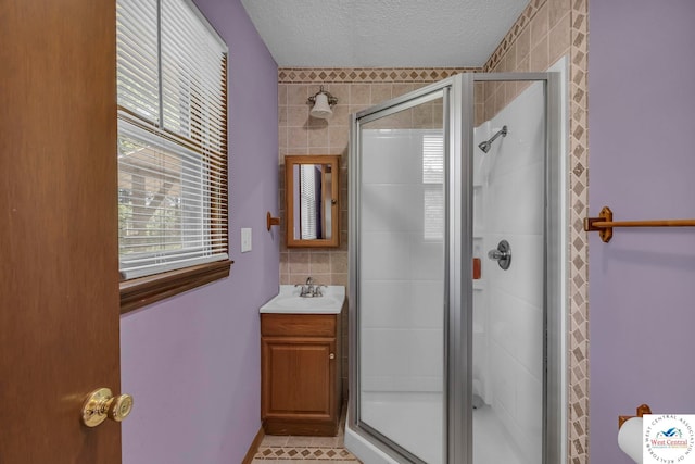 20390 Kindle Rd, Warsaw, MO 65355 - full bath featuring a stall shower, a textured ceiling, vanity, and tile walls