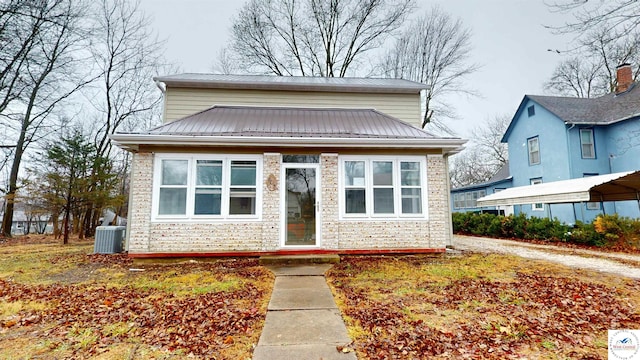 607 E Benton St, Windsor, MO 65360 - bungalow with central AC, metal roof, and stone siding