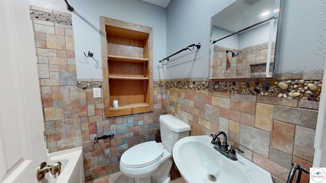 607 E Benton St, Windsor, MO 65360 - bathroom with tile walls, a tub to relax in, toilet, a sink, and a shower