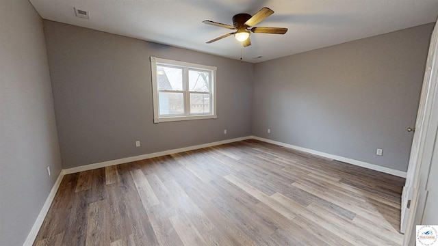 607 E Benton St, Windsor, MO 65360 - unfurnished room with wood finished floors, a ceiling fan, visible vents, and baseboards