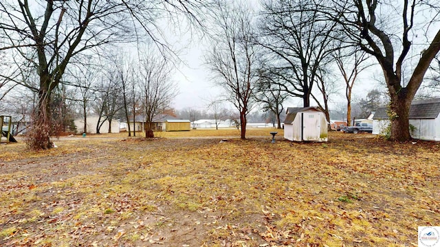 607 E Benton St, Windsor, MO 65360 - view of yard featuring a shed and an outbuilding