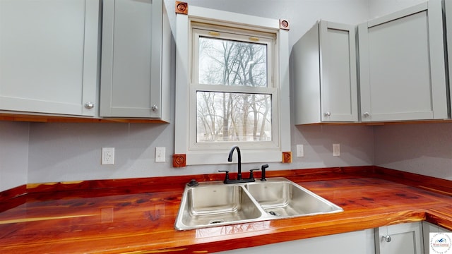 607 E Benton St, Windsor, MO 65360 - kitchen featuring wooden counters and a sink