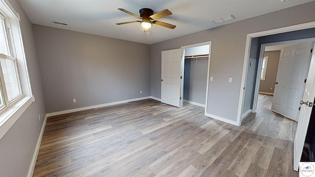 unfurnished bedroom with baseboards, visible vents, and light wood-style floors