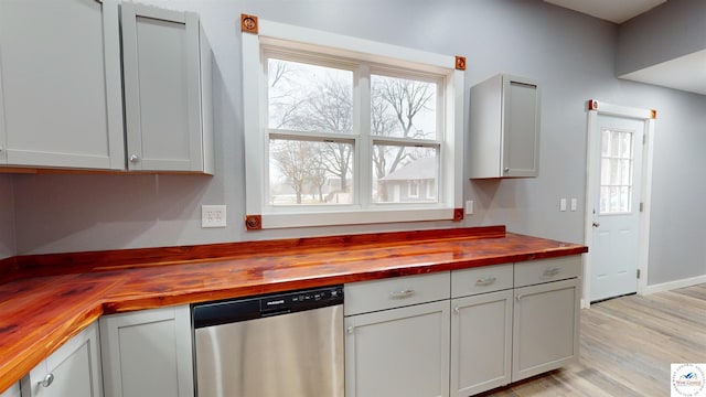 607 E Benton St, Windsor, MO 65360 - kitchen featuring wood counters, a wealth of natural light, light wood-type flooring, and dishwasher