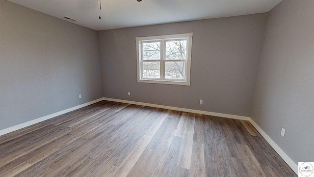 607 E Benton St, Windsor, MO 65360 - unfurnished room with baseboards, visible vents, and wood finished floors