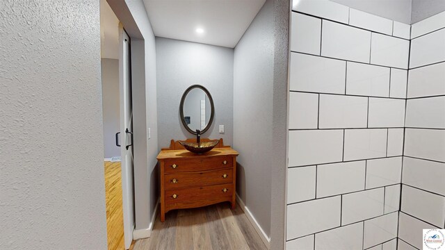 607 E Benton St, Windsor, MO 65360 - hallway with a textured wall, wood finished floors, and baseboards