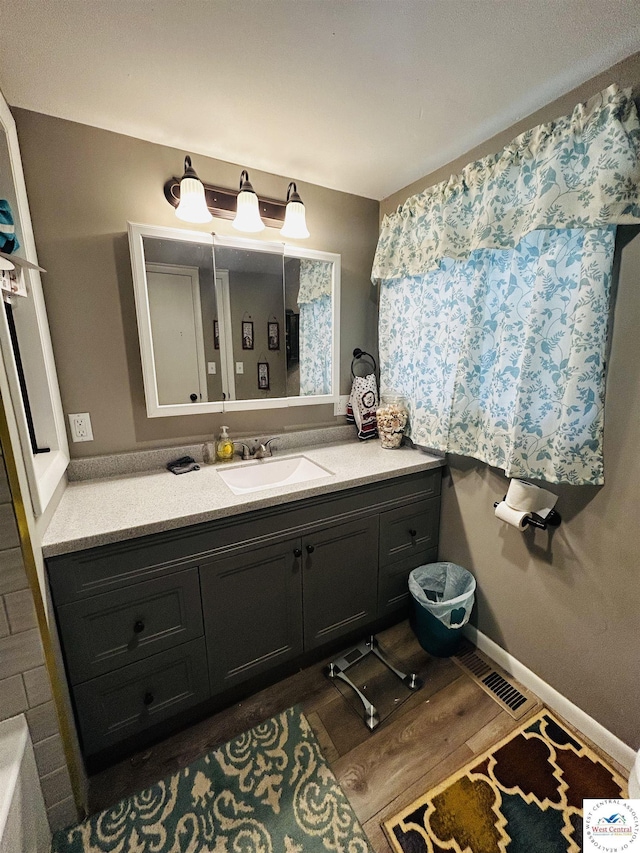 106 W Fairview St, Clinton, MO 64735 - bathroom with vanity and wood finished floors