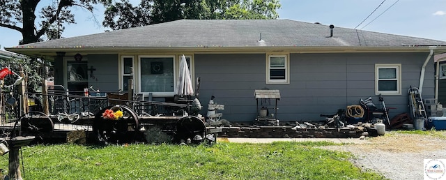 106 W Fairview St, Clinton, MO 64735 - rear view of house with a yard, roof with shingles, and covered porch