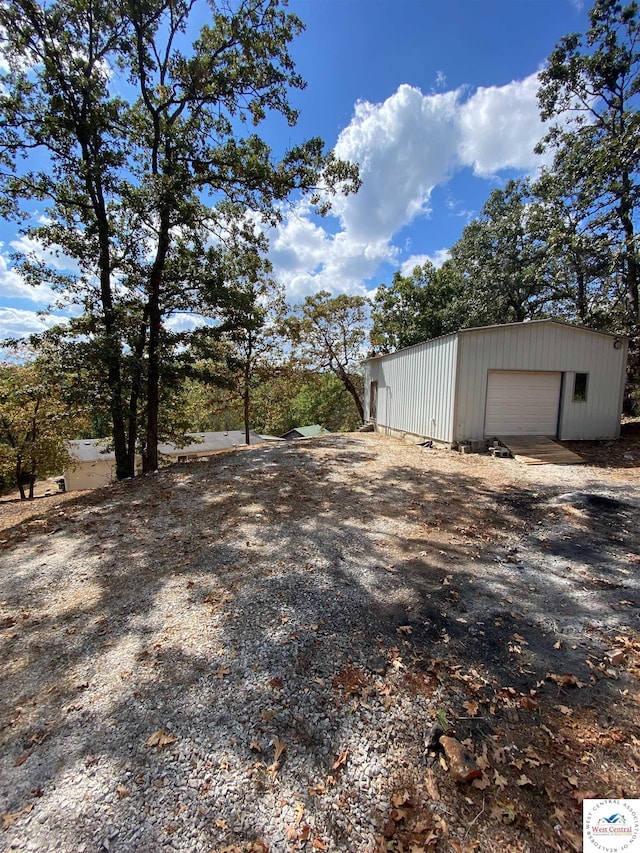 11371 Dawn Dr, Warsaw, MO 65355 - view of yard featuring an outdoor structure, a garage, and driveway