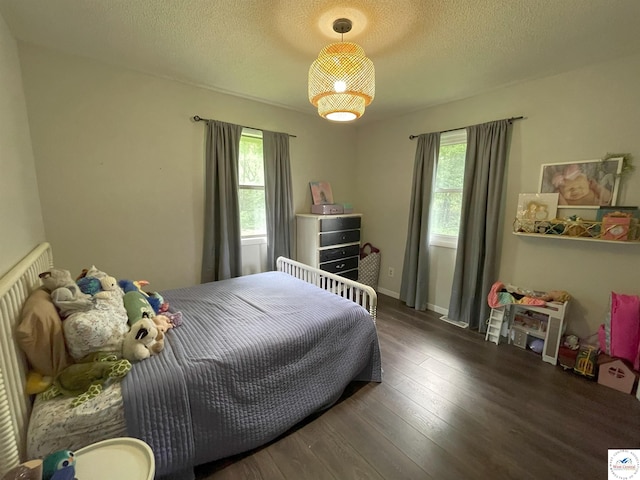 22756 Hickory Chapel Ave, Lincoln, MO 65338 - bedroom featuring multiple windows, wood finished floors, and a textured ceiling